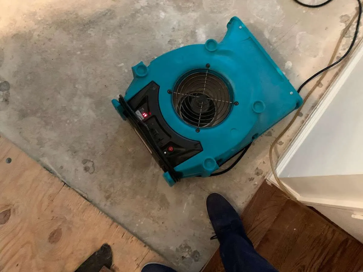 Air mover drying subfloor during Leak Detection & Repair in New York